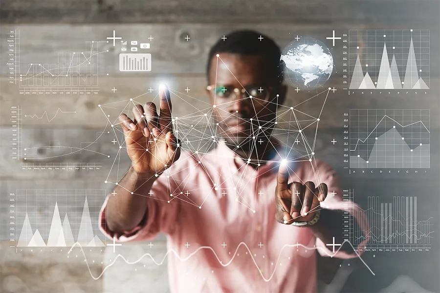 Black man explaining an idea in front of a chalkboard